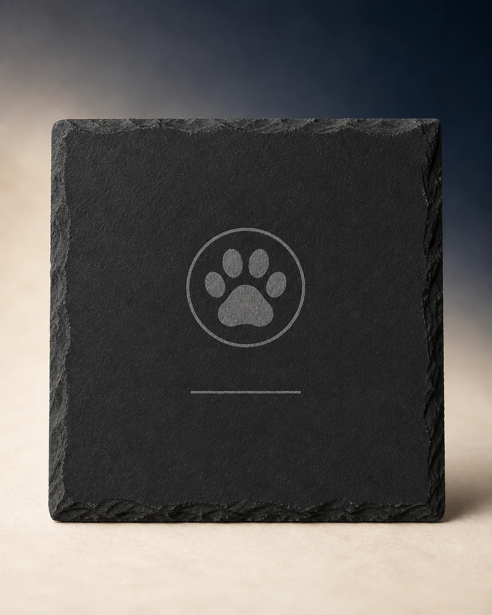 Dark slate engraving example with a paw motif