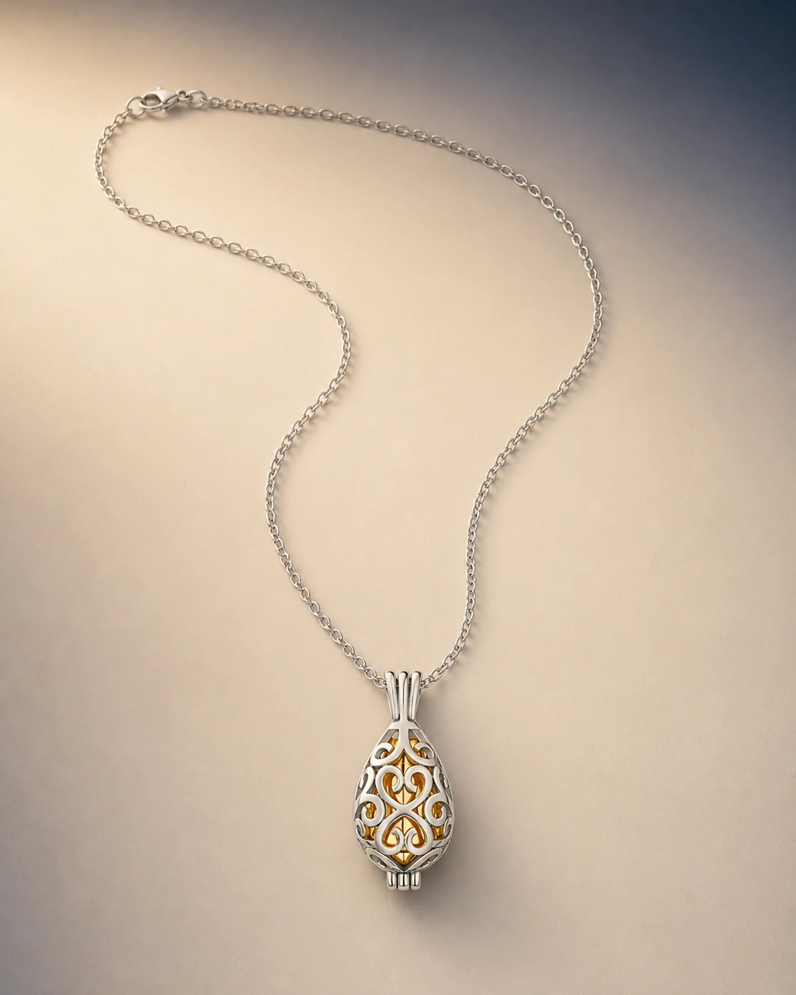 Silver openwork lotus keepsake necklace with a warm-gold inner closure