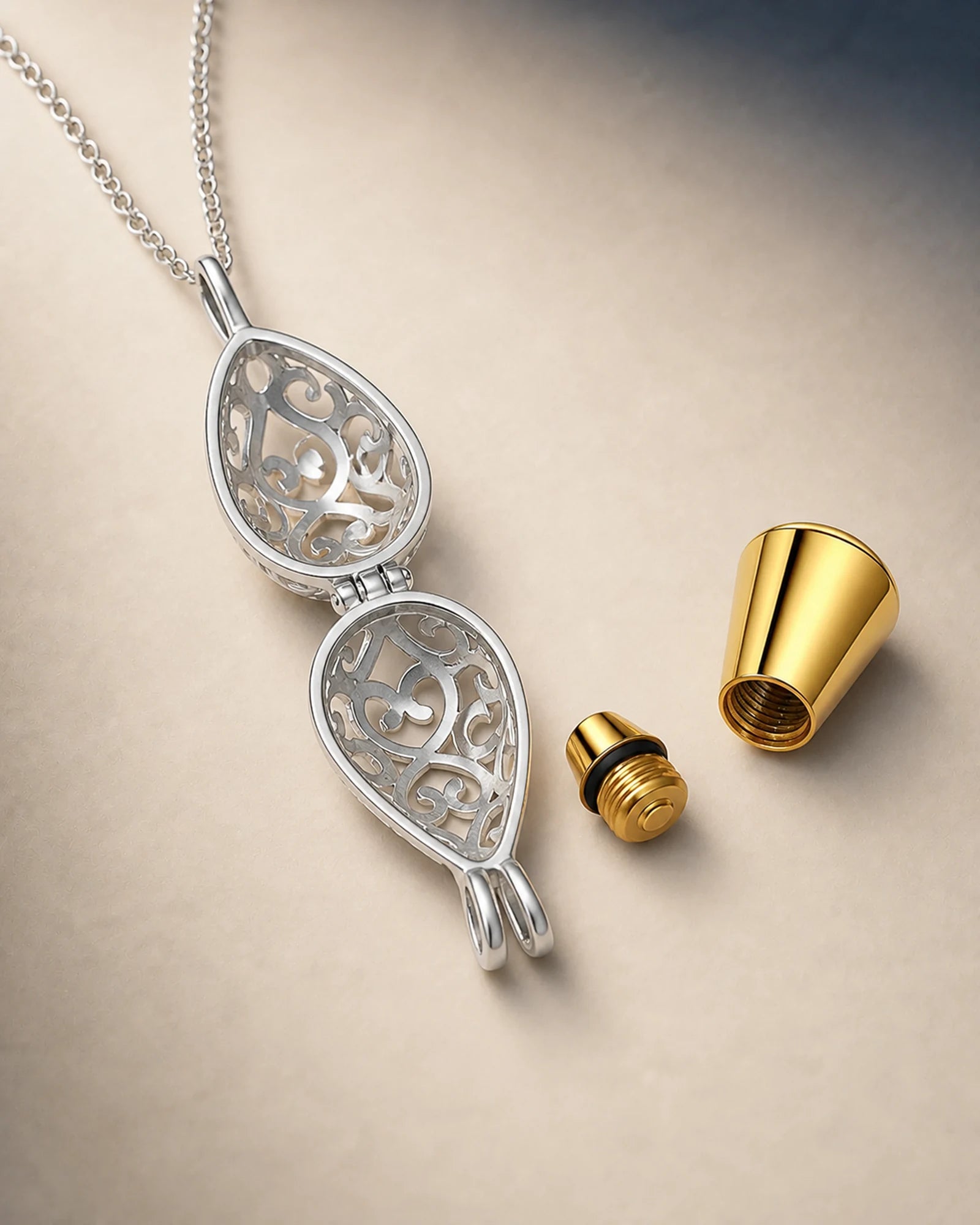 Lotus keepsake pendant with open cage, removable inner capsule, threaded stopper and sealing ring