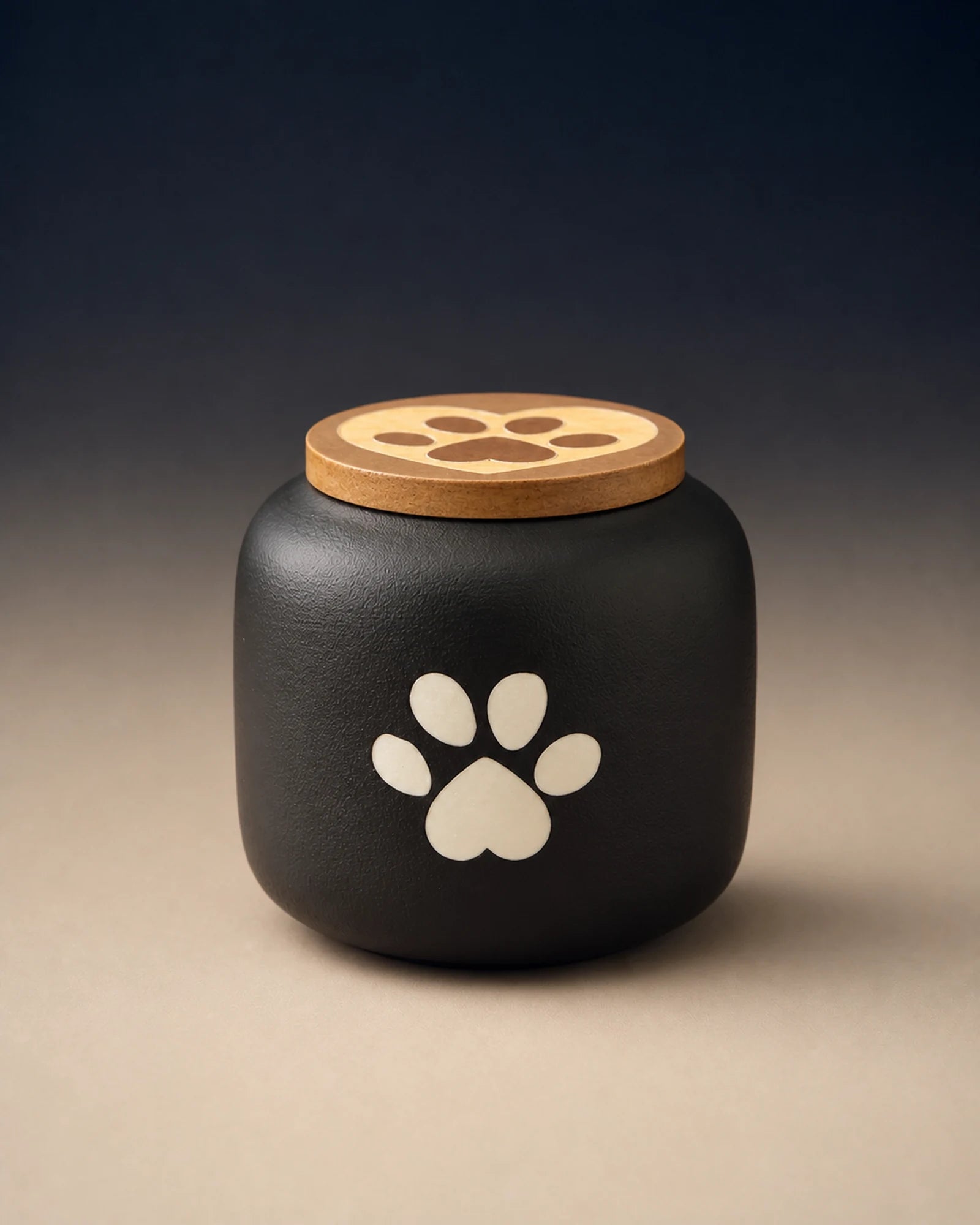 Black 180 mL pawprint memorial urn with a wooden lid