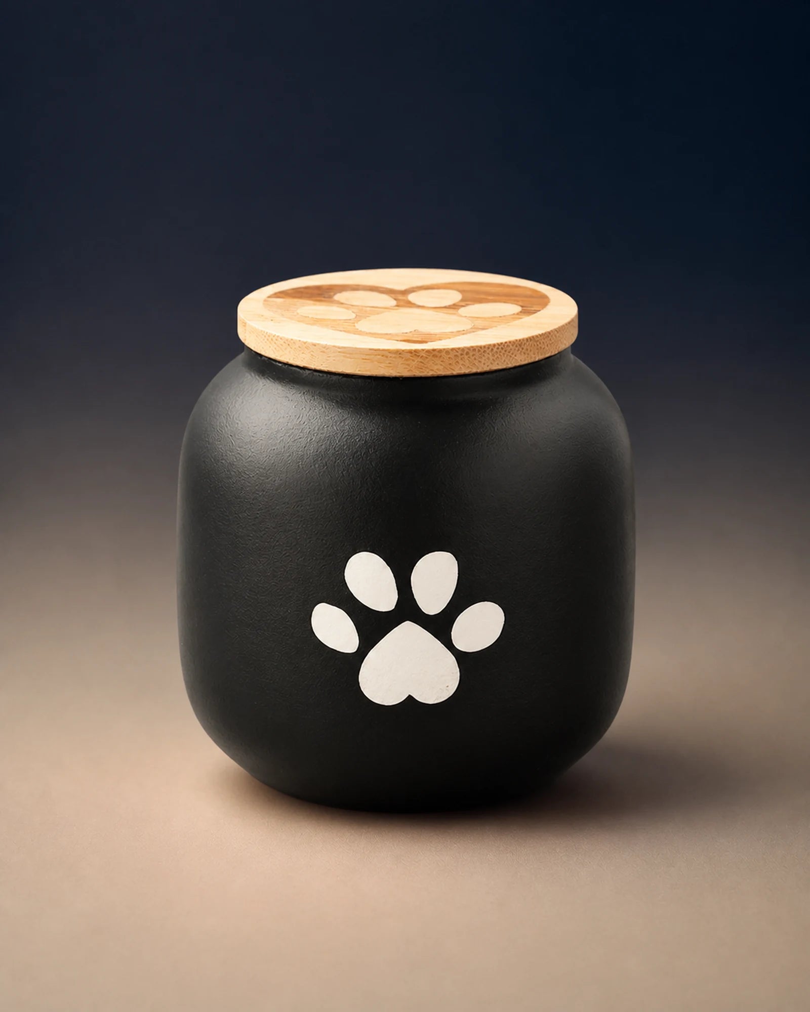 Black 500 mL pawprint memorial urn with a wooden lid